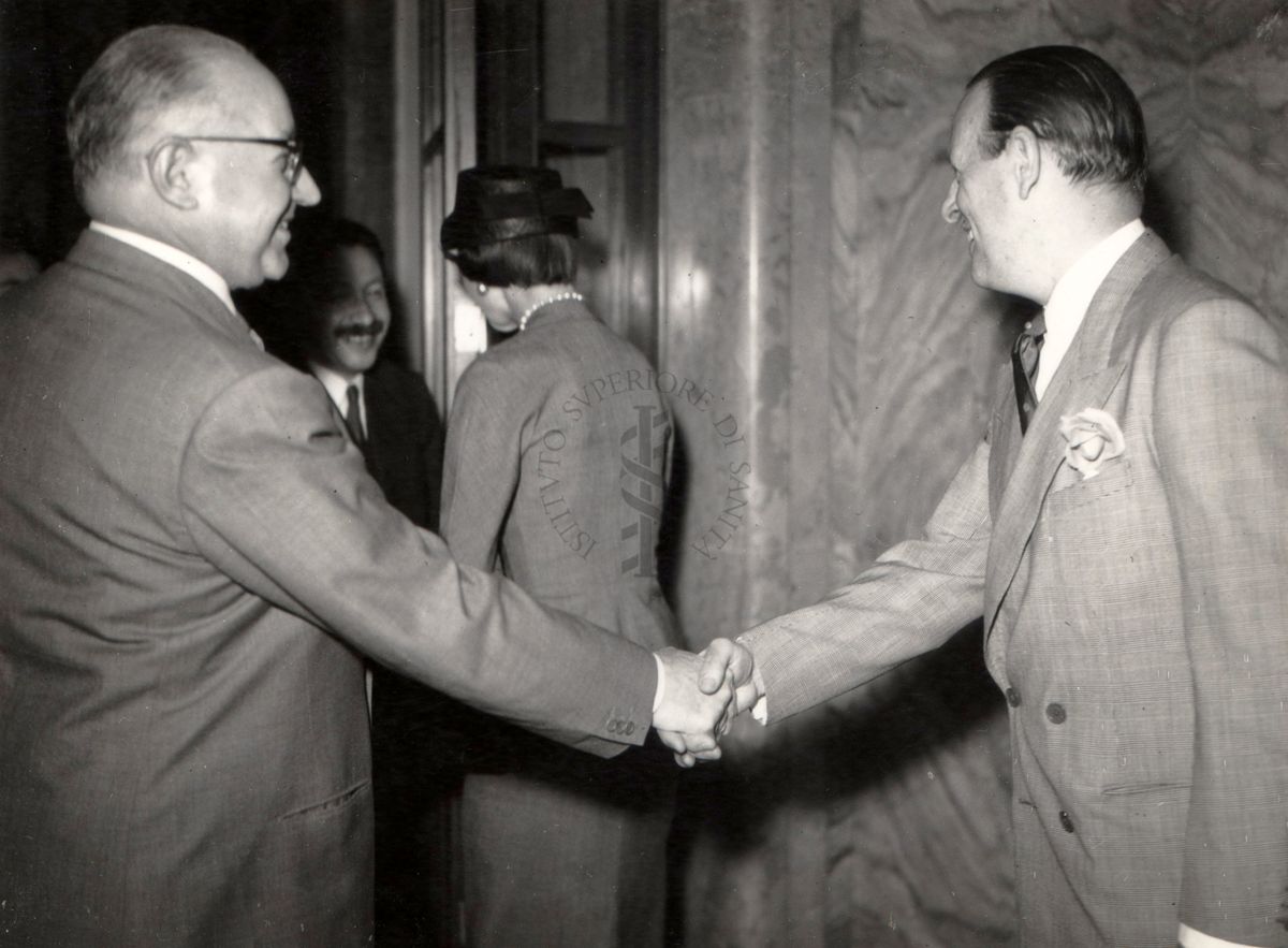 L'Ambasciatore Britannico Sir Ashley Clarke e signora, stringono la mano al prof. Domenico Marotta (direttore dell'I.S.S.) ed al prof. Ernst Boris Chain.