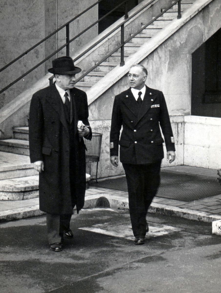 Sua Eccellenza Petretti (a sinistra) e  il prof. Domenico Marotta (lato destro) passeggiano nel cortile dell'Istituto Superiore di Sanità.