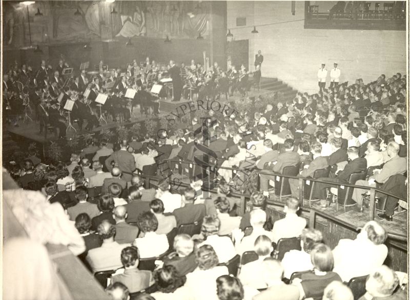 Ripresa dall'alto di parte del pubblico di spalle e dell'intera orchestra durante il Concerto tenuto nell'Aula Magna della Città Universitaria in occasione del Congresso