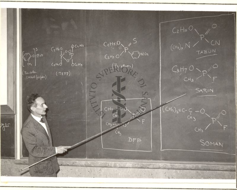 Il Prof. Bovet illustra formule chimiche alla lavagna di un'aula dell'Istituto Superiore di Sanità